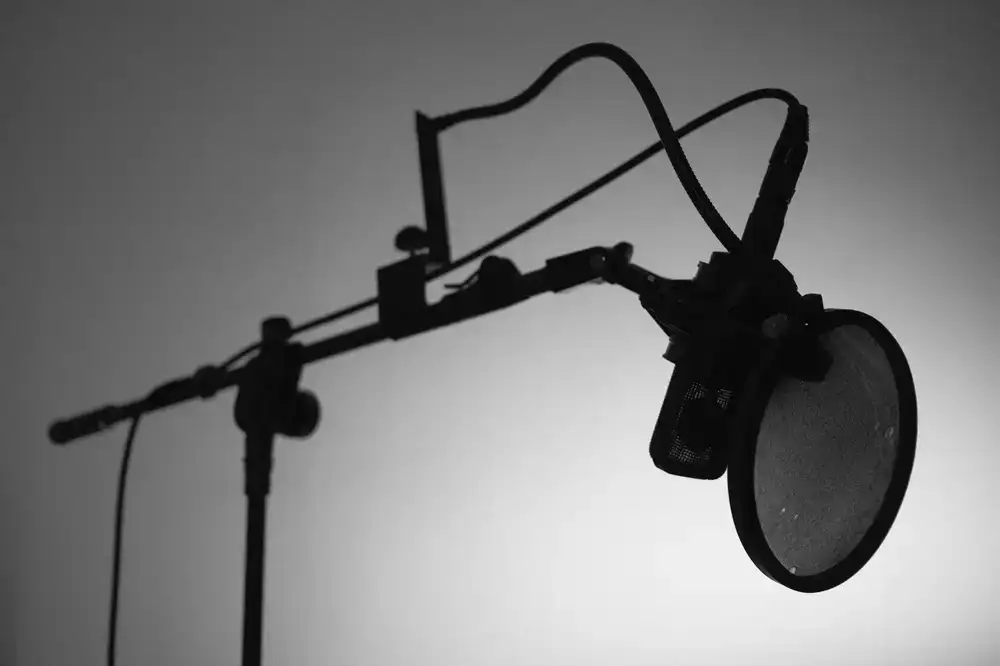 XLR microphone attached to a low-profile boom arm